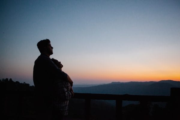 A happy couple embracing at sunset