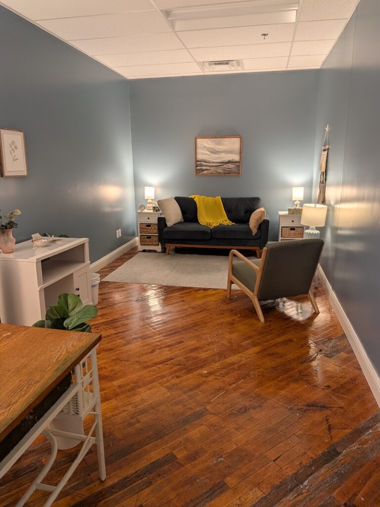 A couch and a chair with space for individuals or couples to engage in therapy or EMDR